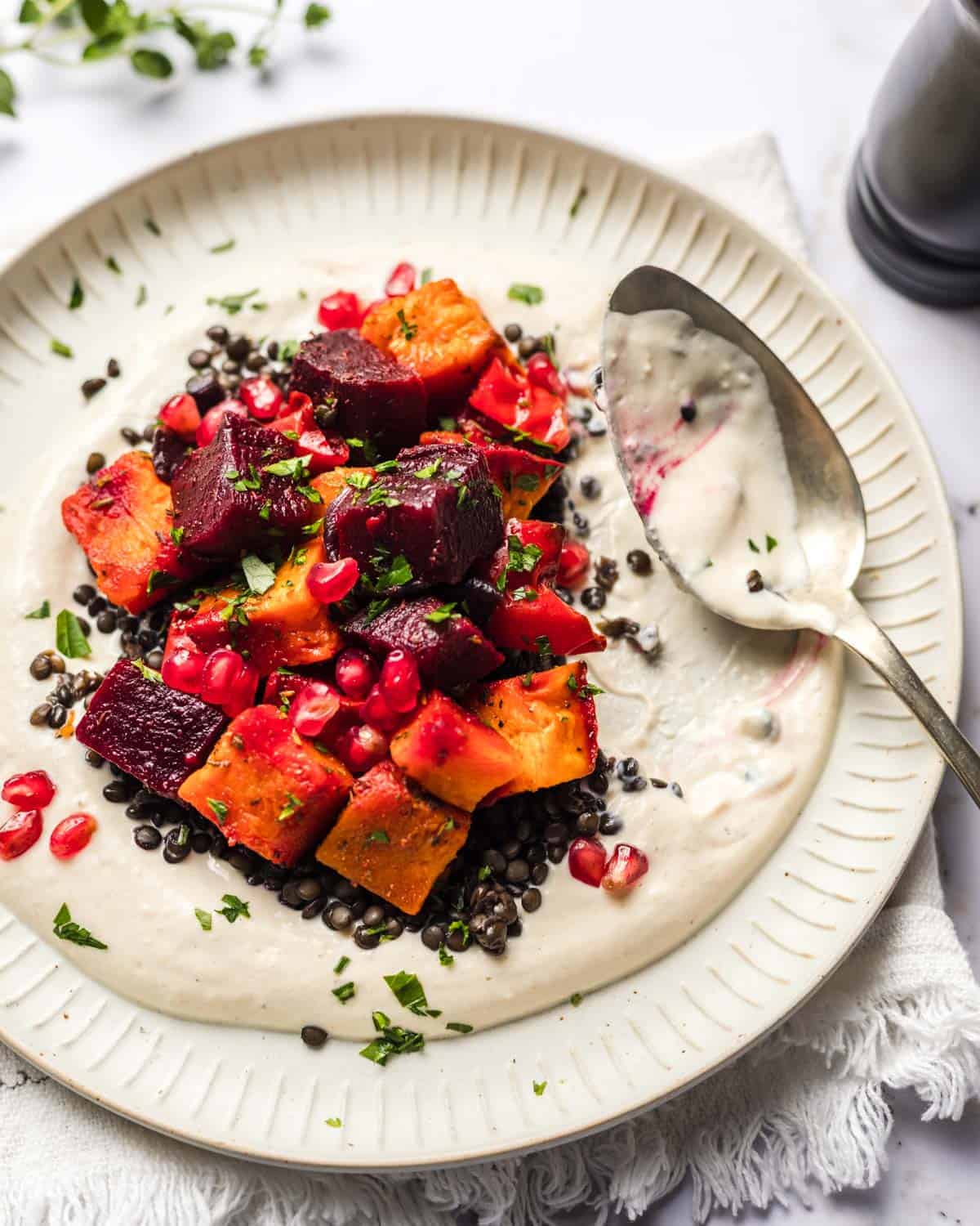 oven roasted vegetables on yogurt tahini sauce and lentils