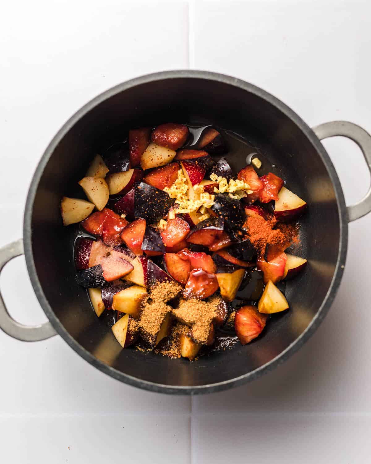 chopped plums in pot for bbq sauce