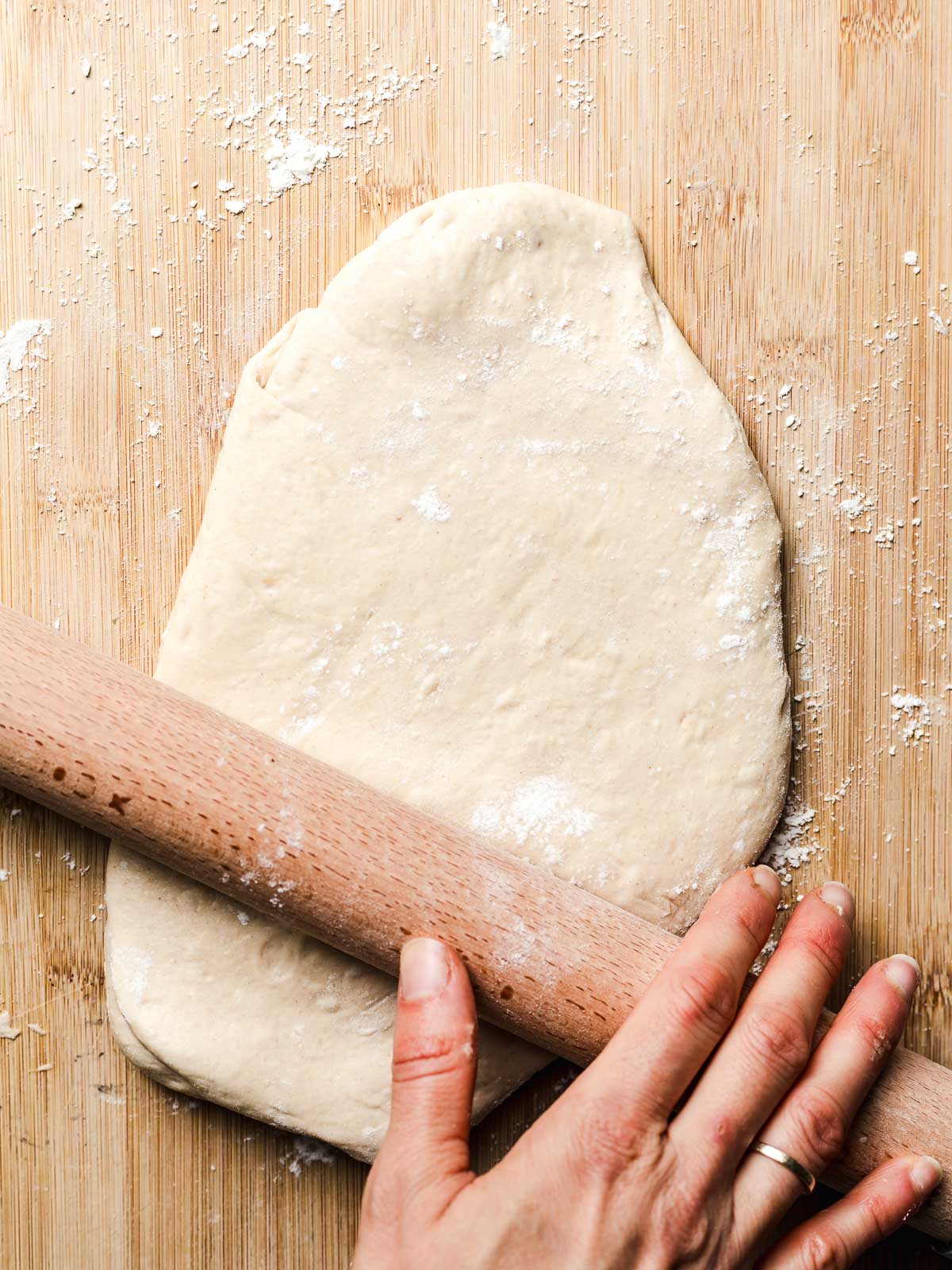 rolling out pizza dough