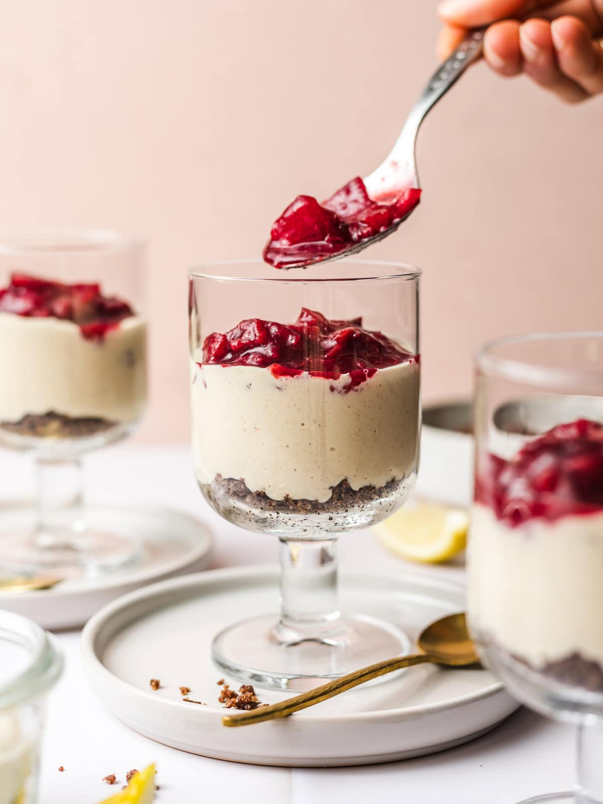 plant-based cheesecake cups with plum compote and nutty crumble