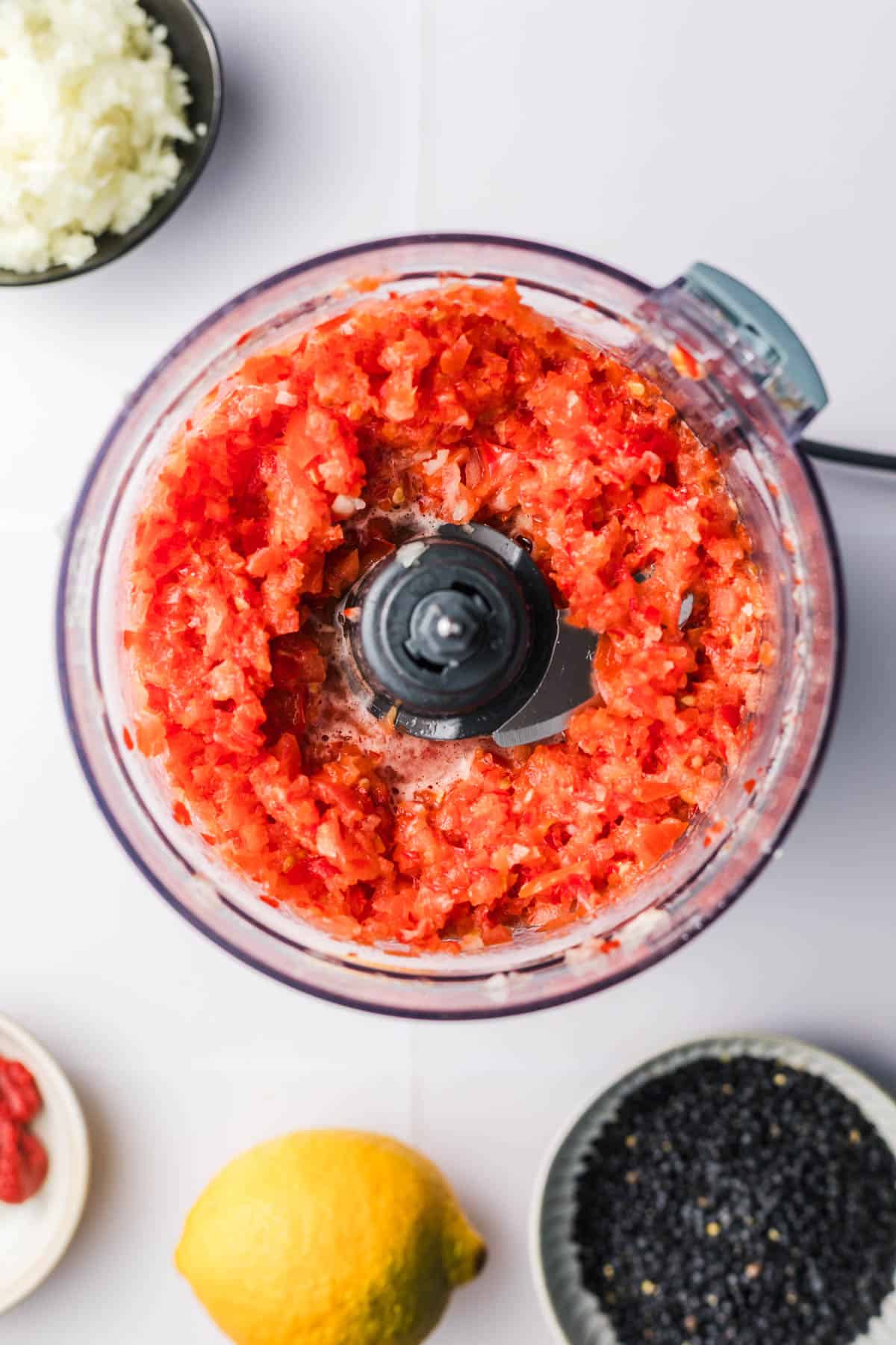 chopped tomatoes and peppers in food processor