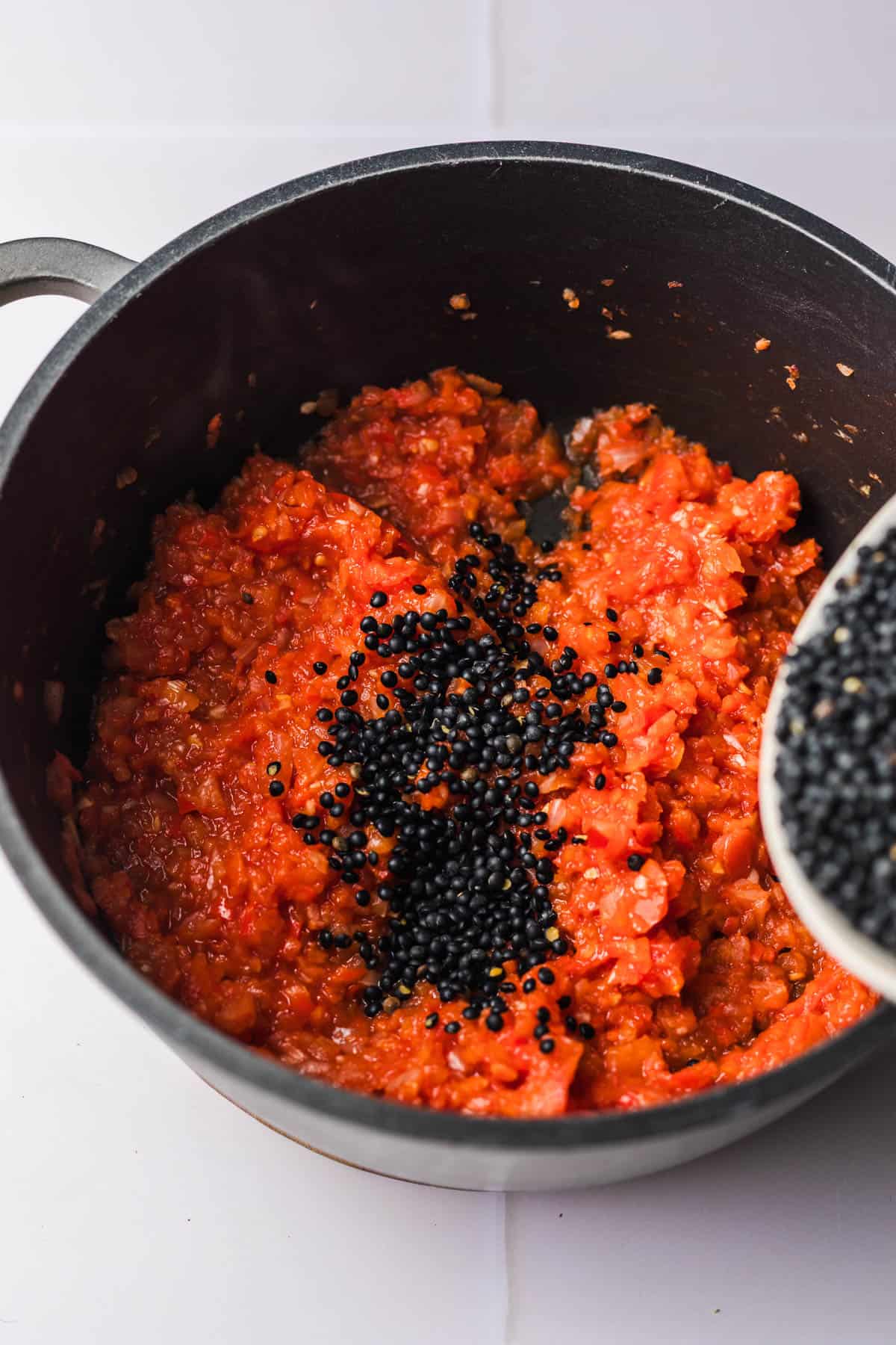 beluga lentil recipe with tomatoes in pot