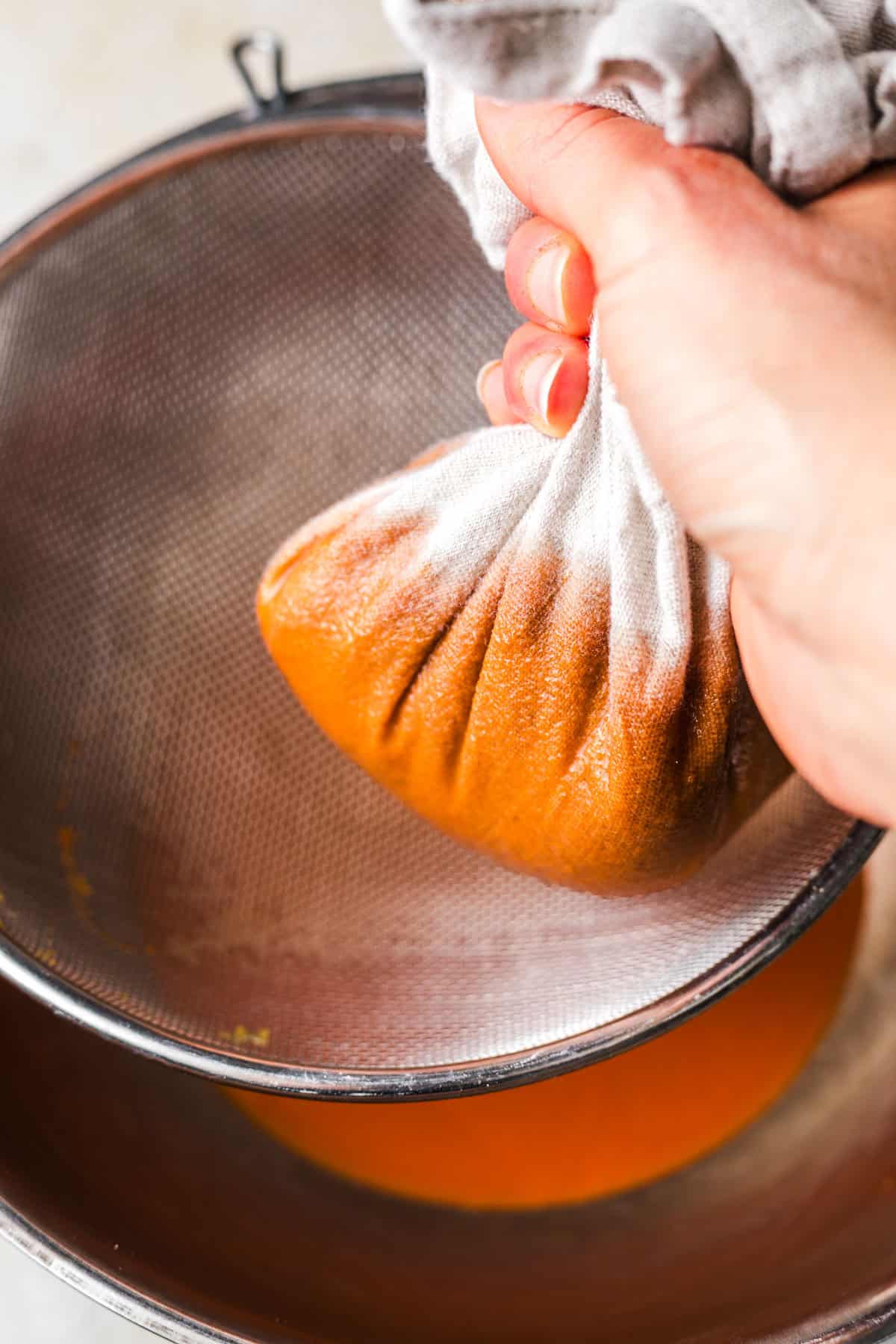 straining carrot juice syrup