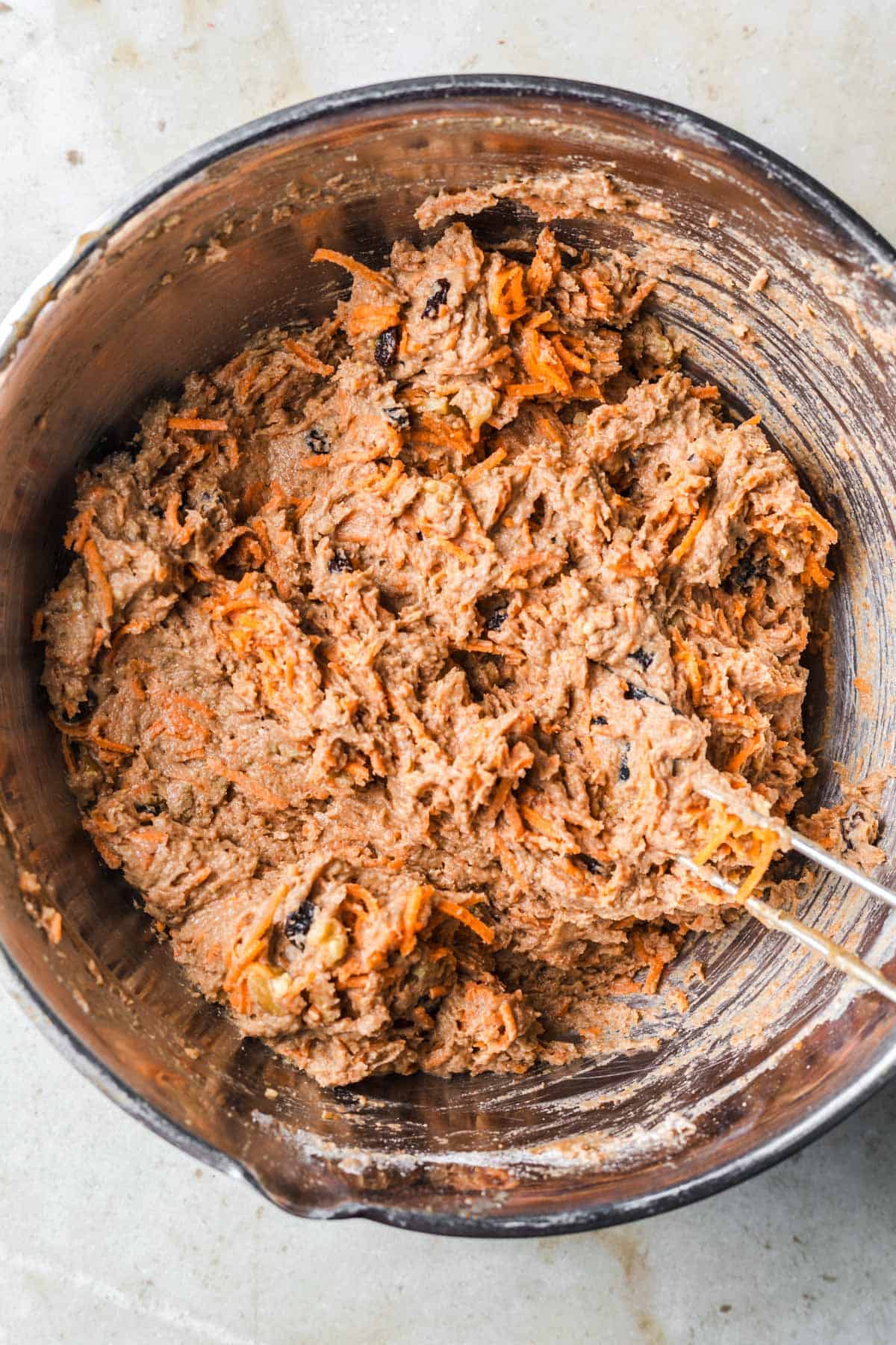 vegan carrot cake batter with raisins and walnuts