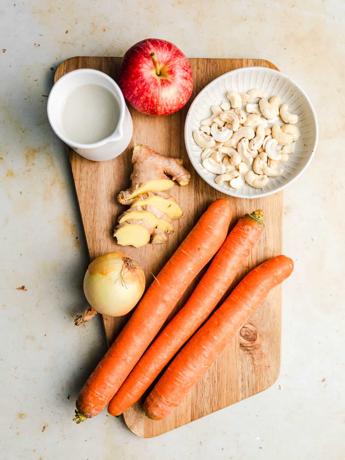ingredients for creamy vegan carrot soup with ginger and apple