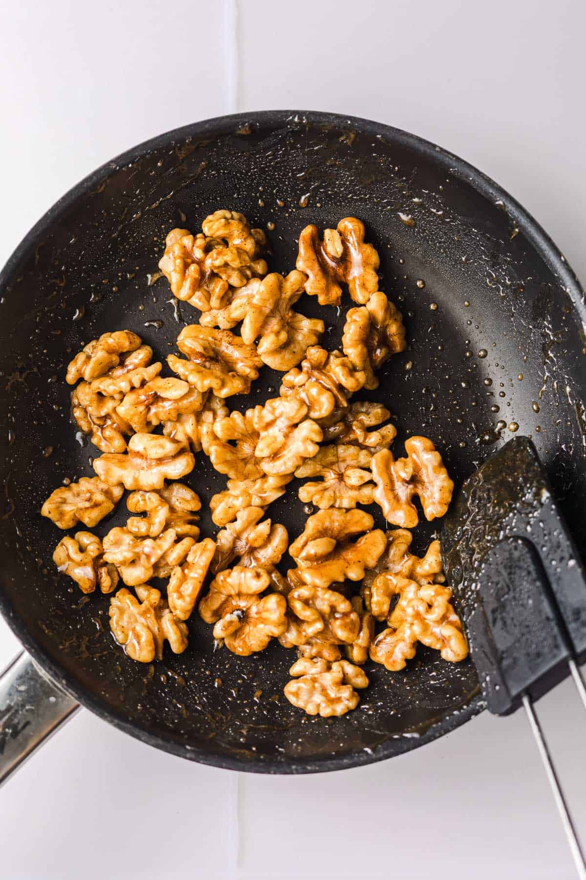 maple glazed walnuts in pan
