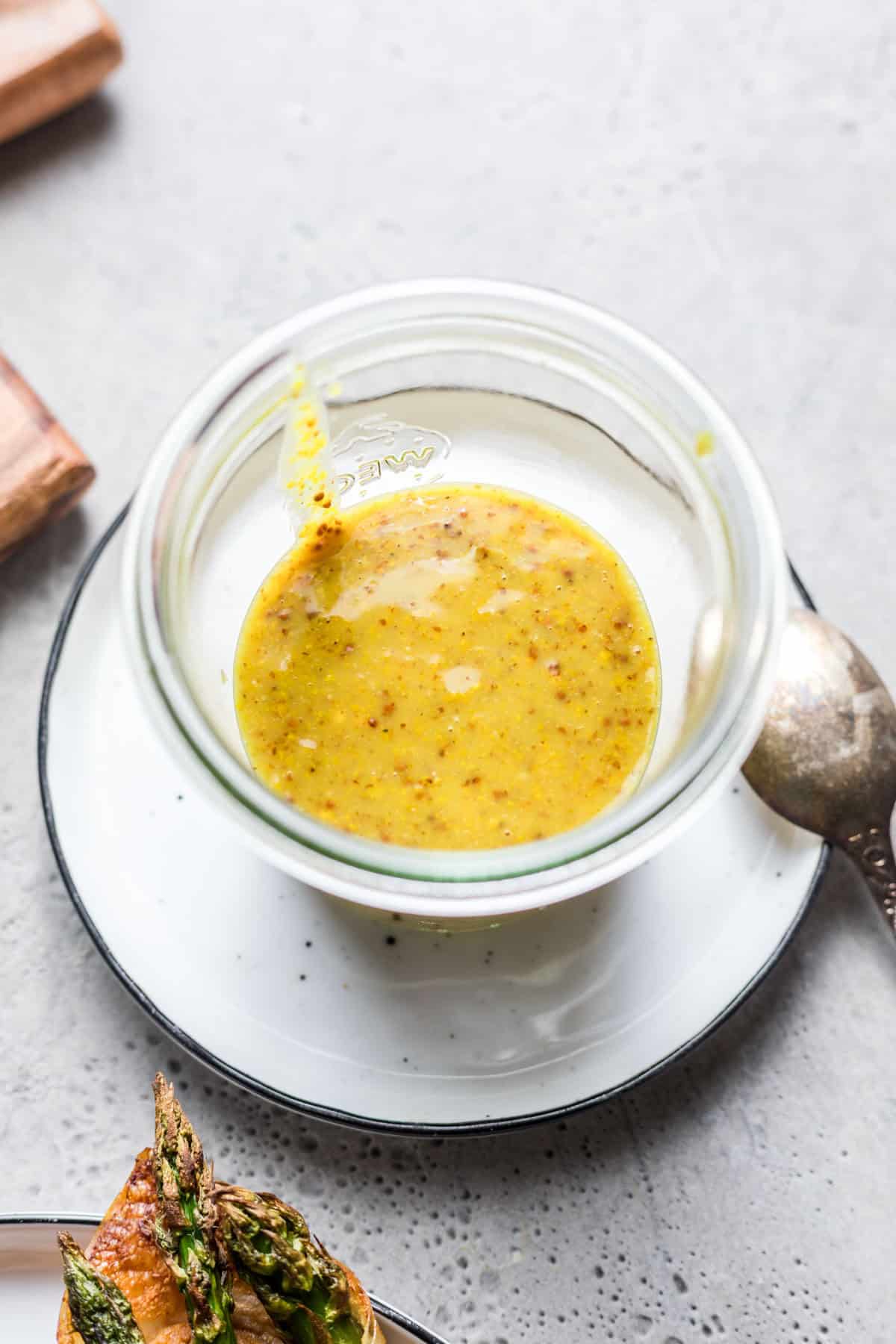 Homemade vegan sweet mustard dressing in a small glass bowl
