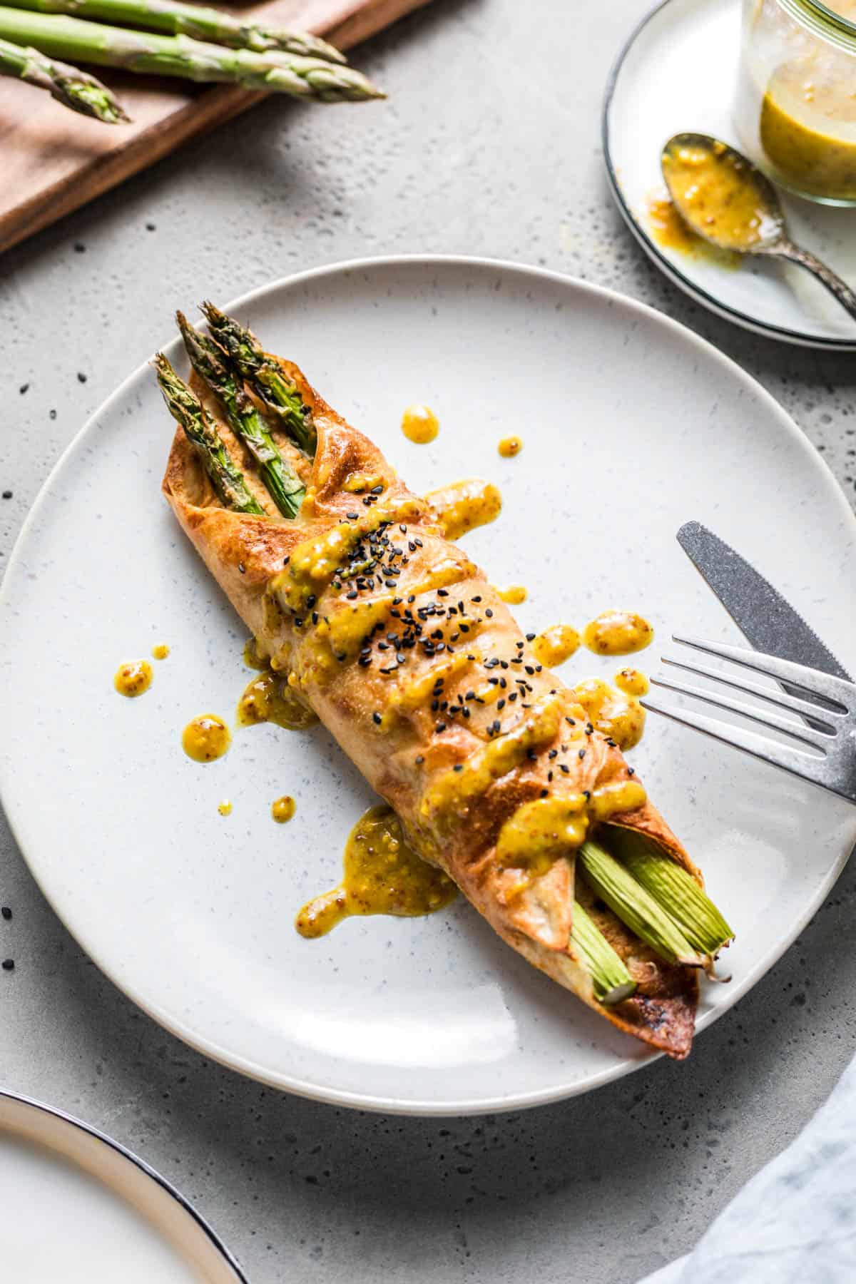 gluten-free vegan green asparagus rice paper parcels drizzled with sweet mustard dressing