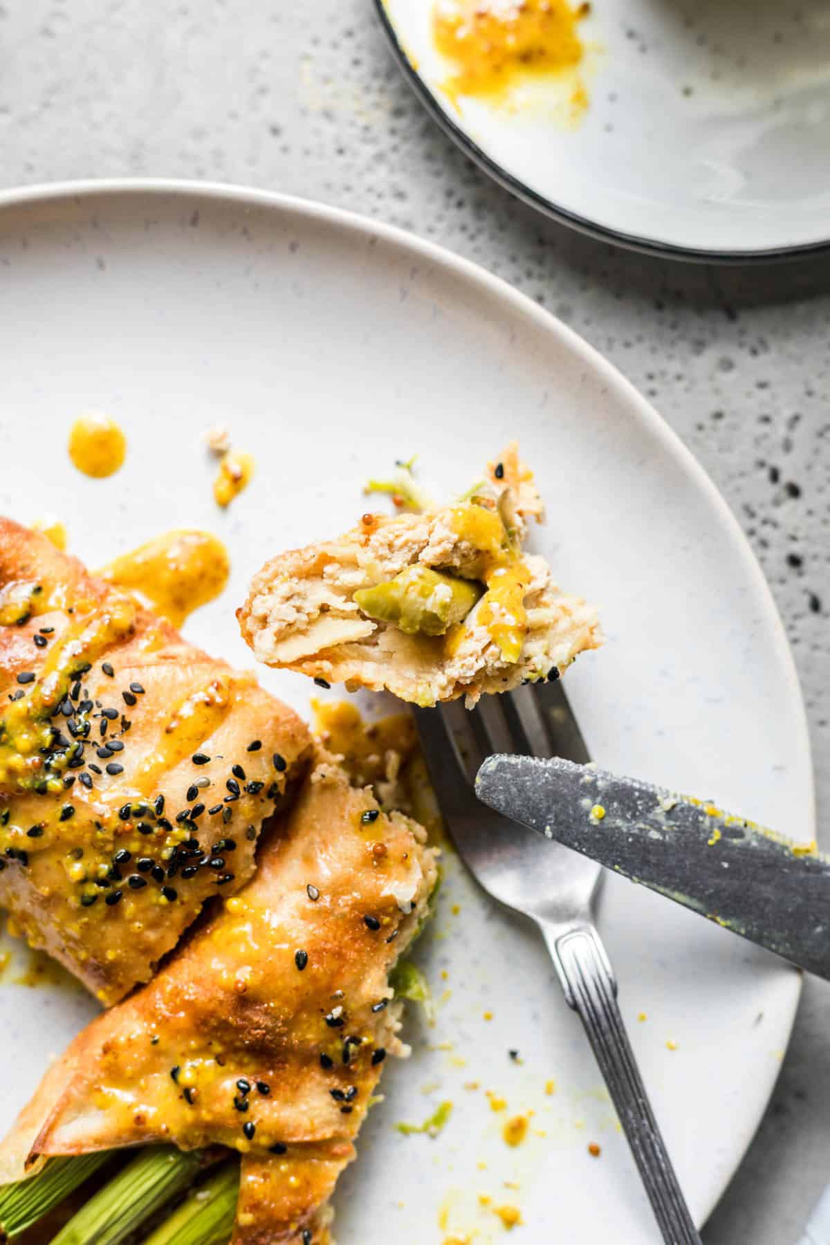 Oven-baked vegan asparagus parcels with smoked tofu filling on a plate