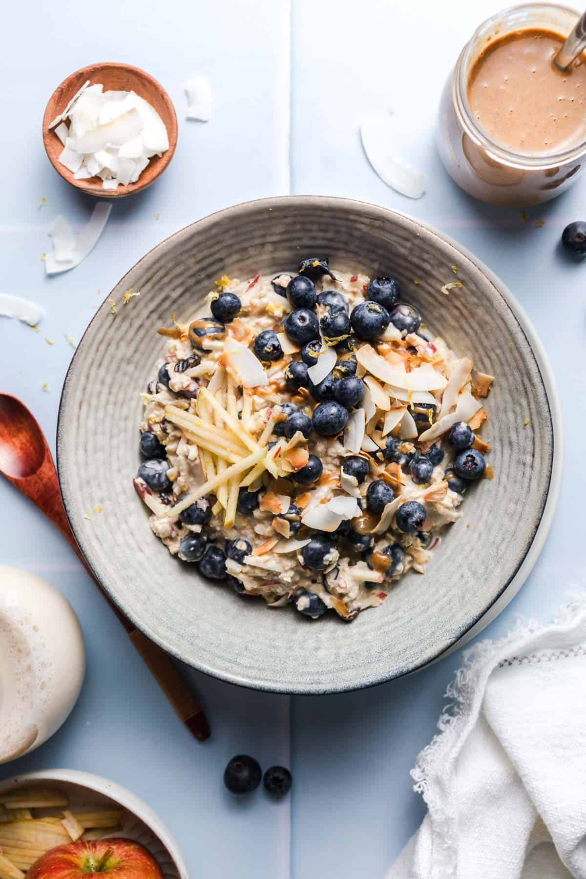 Vegan blueberry coconut Bircher muesli in a bowl topped with fresh blueberries