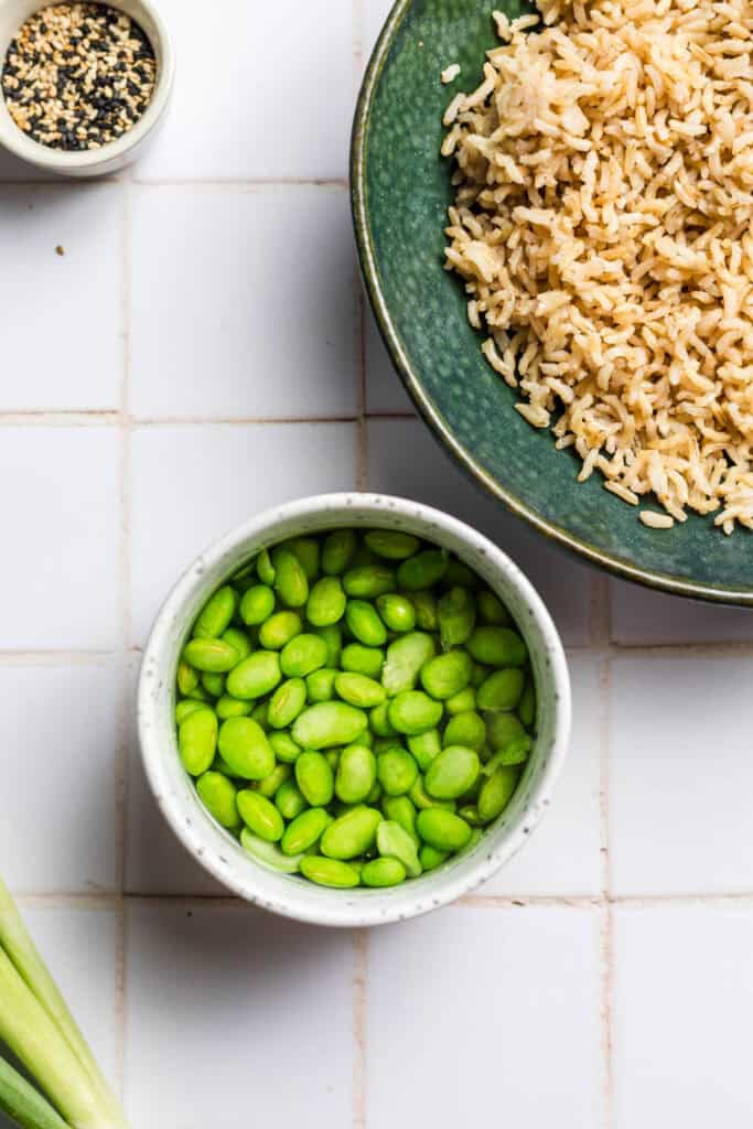 Edamame beans and seasoned sushi rice in bowls
