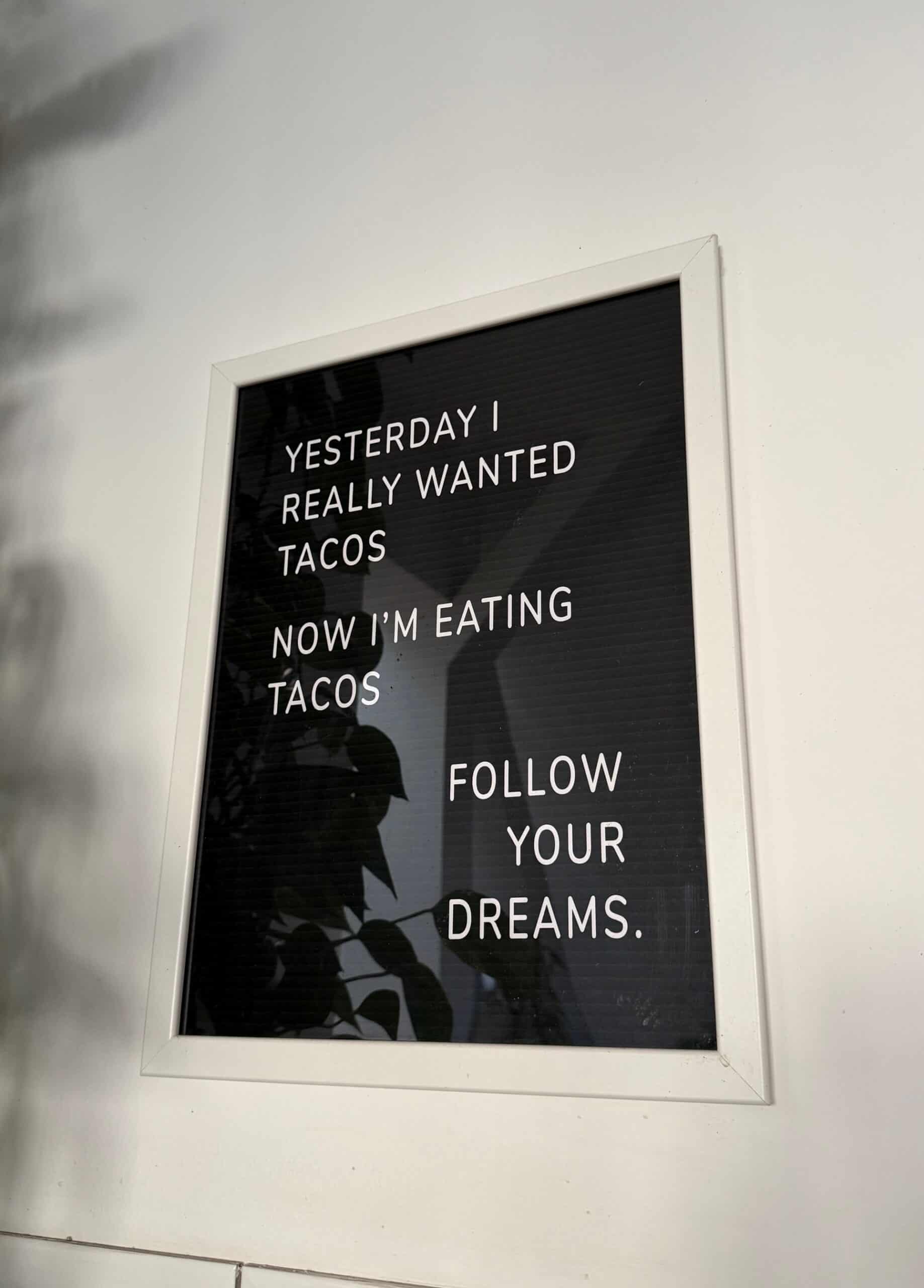 A vintage-style poster with a funny quote about tacos