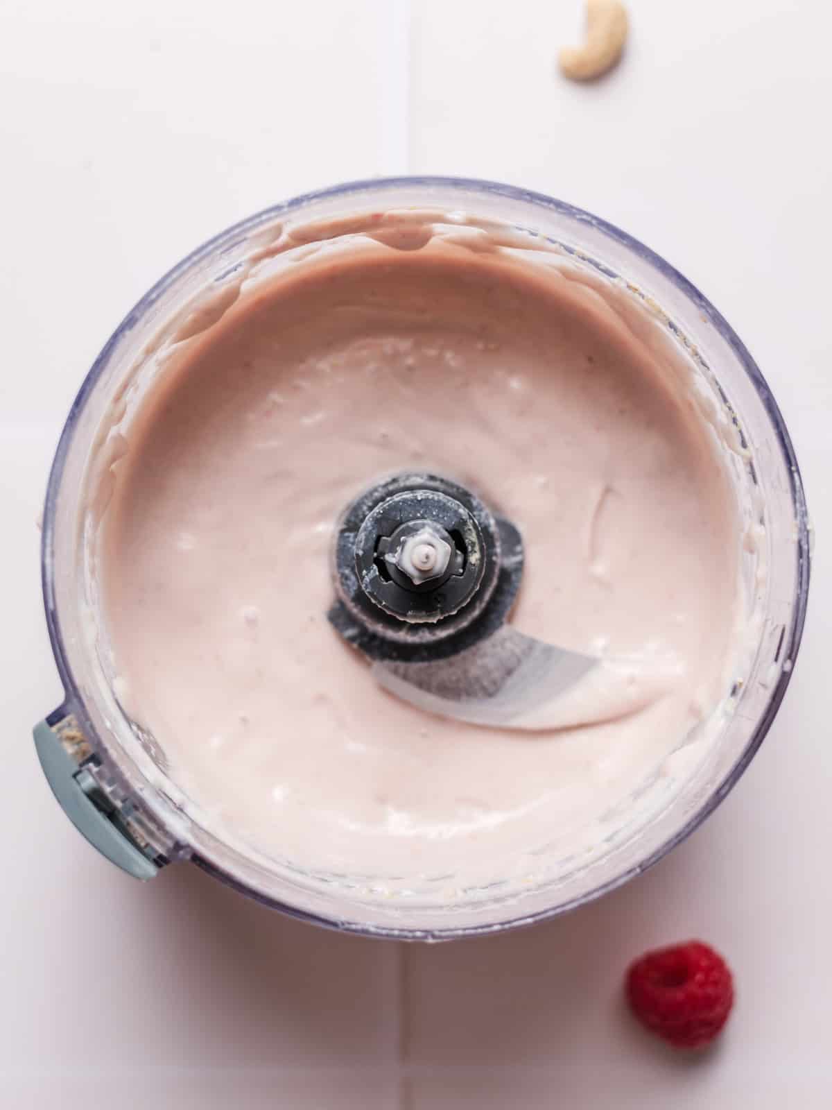 Vegan raspberry yogurt cream in a blender