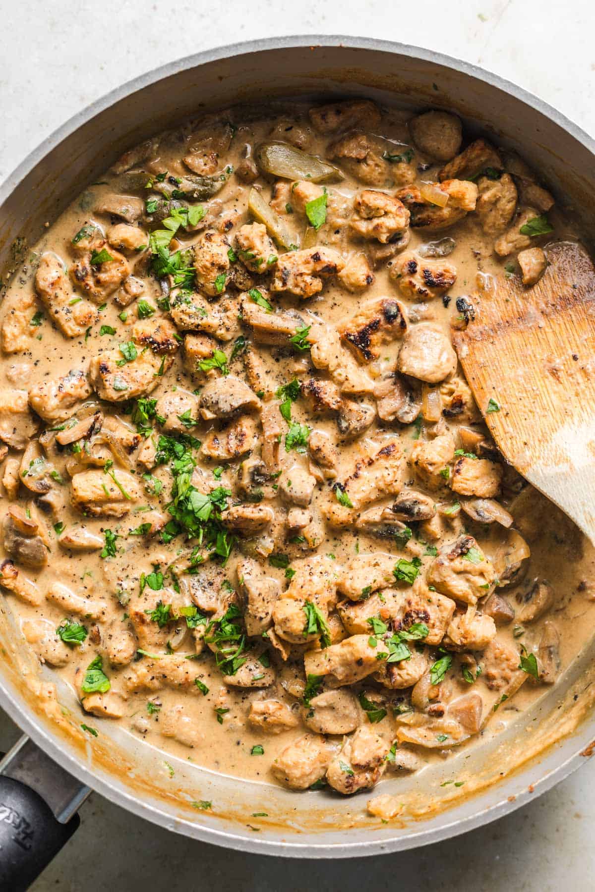 Vegan soy-mushroom stroganoff in a skillet, finished and ready to serve without any cream