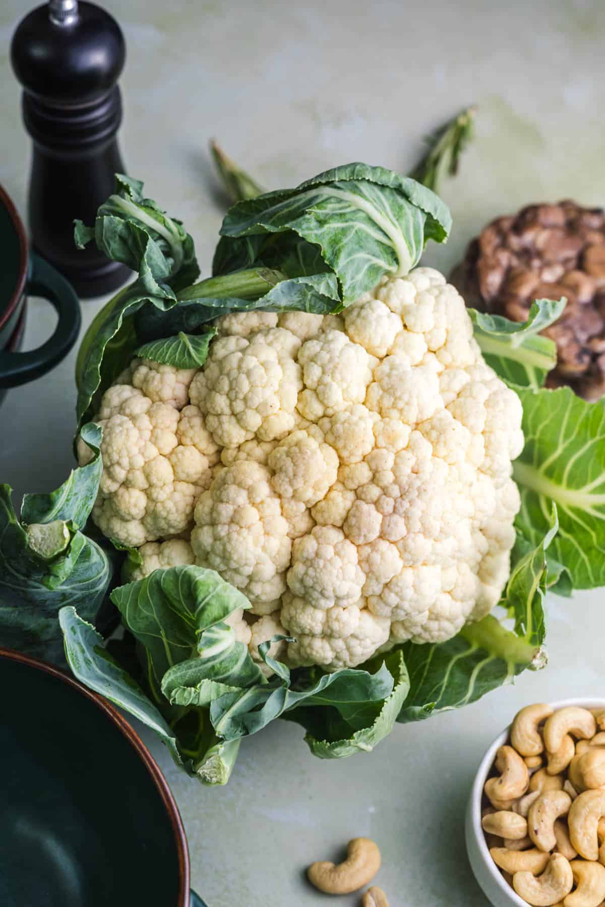 Whole head of cauliflower with cashews and chestnuts – ingredients for the vegan soup