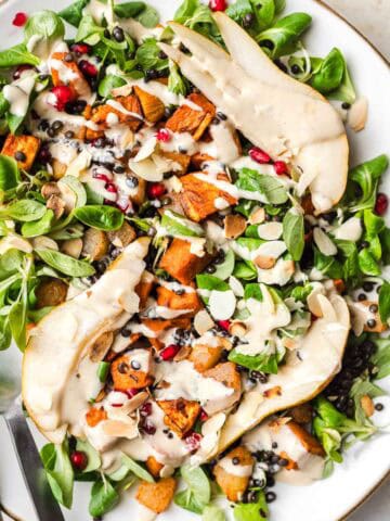 roasted sweet potato on greens with tahini dressing