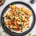 roasted cauliflower and chickpeas on tahin and israeli couscous