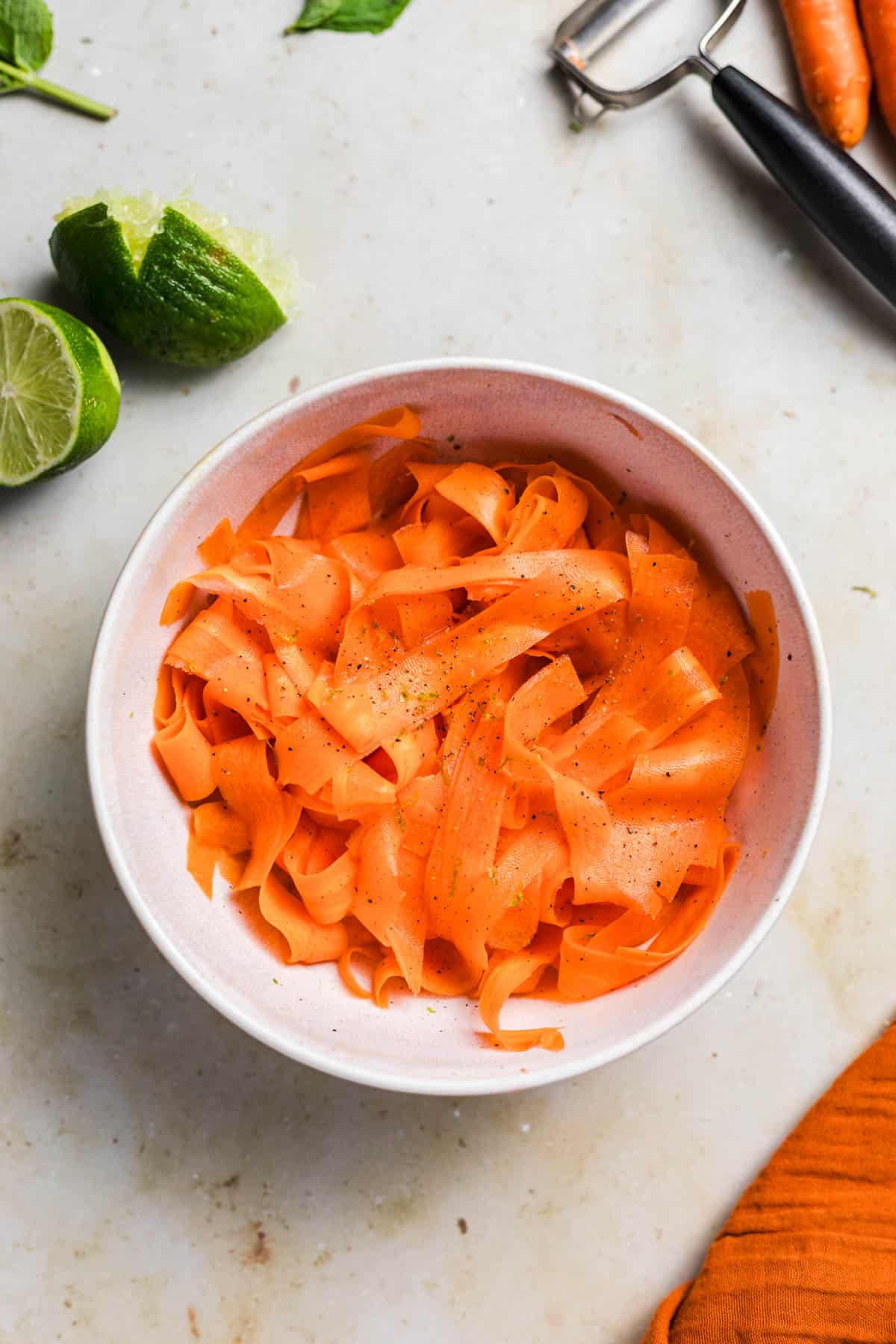 Quick lime carrot ribbon salad with maple syrup dressing in a bowl
