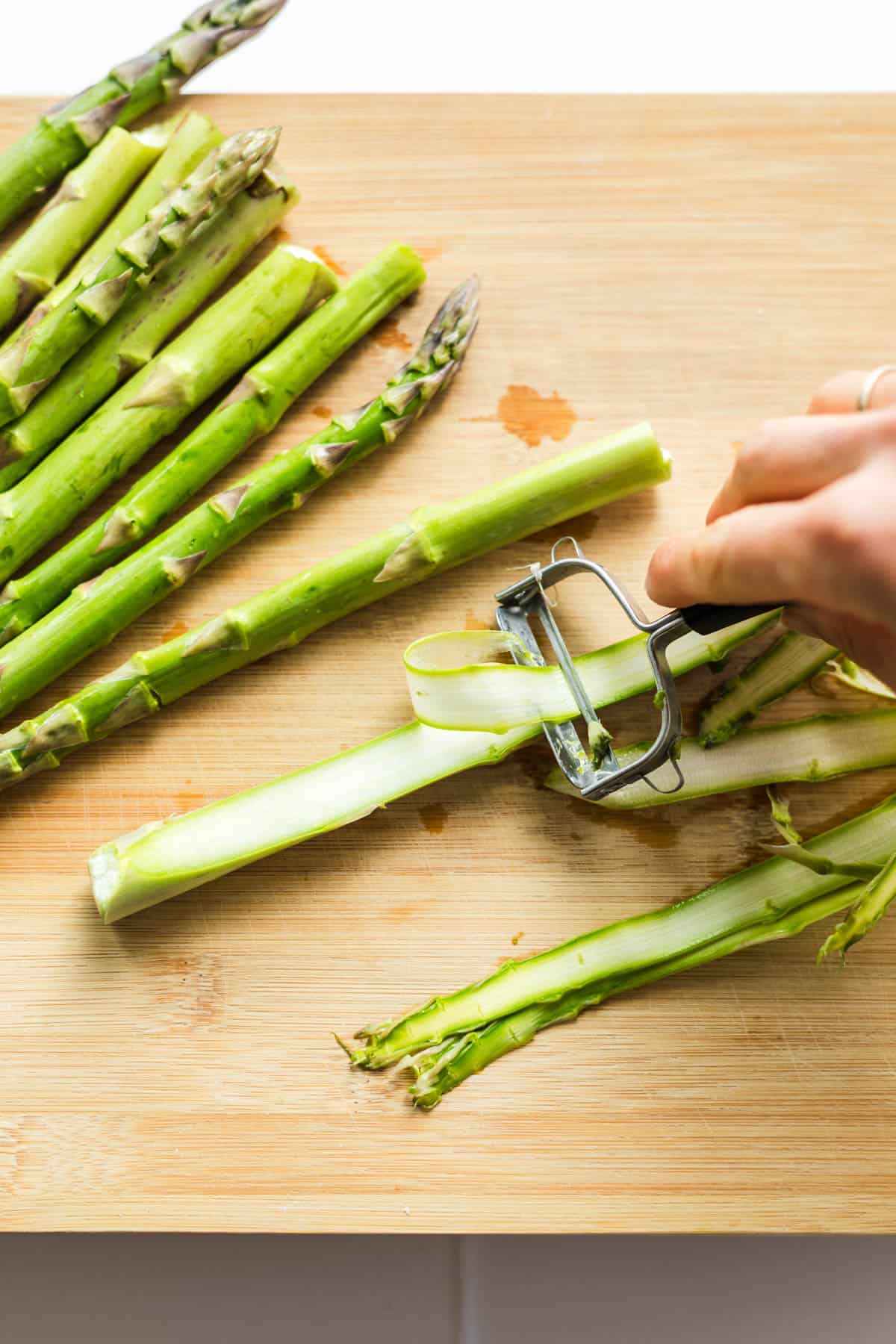 Raw green asparagus shaved into thin ribbons