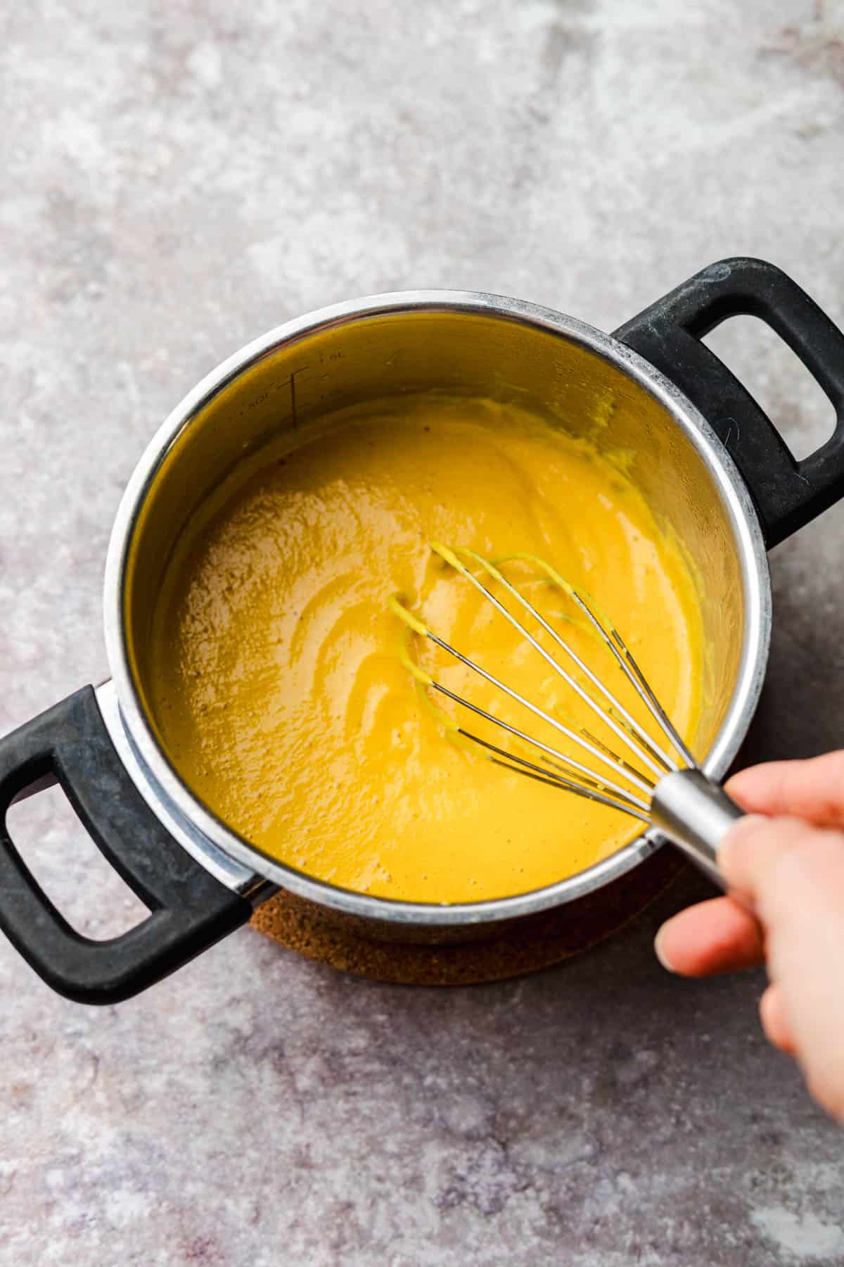 Creamy vegan nacho cheese sauce made from carrot and cauliflower, no cashews needed