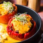Vegan stuffed peppers without meat substitute, topped with creamy pumpkin sauce