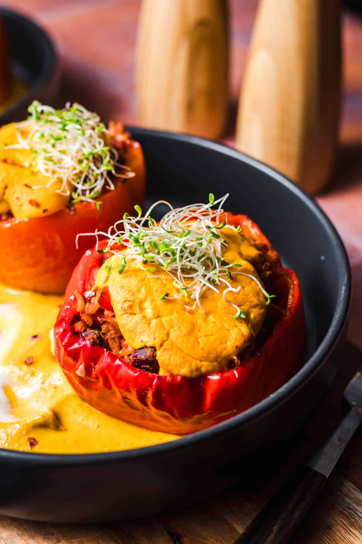Vegan stuffed peppers without meat substitute, topped with creamy pumpkin sauce