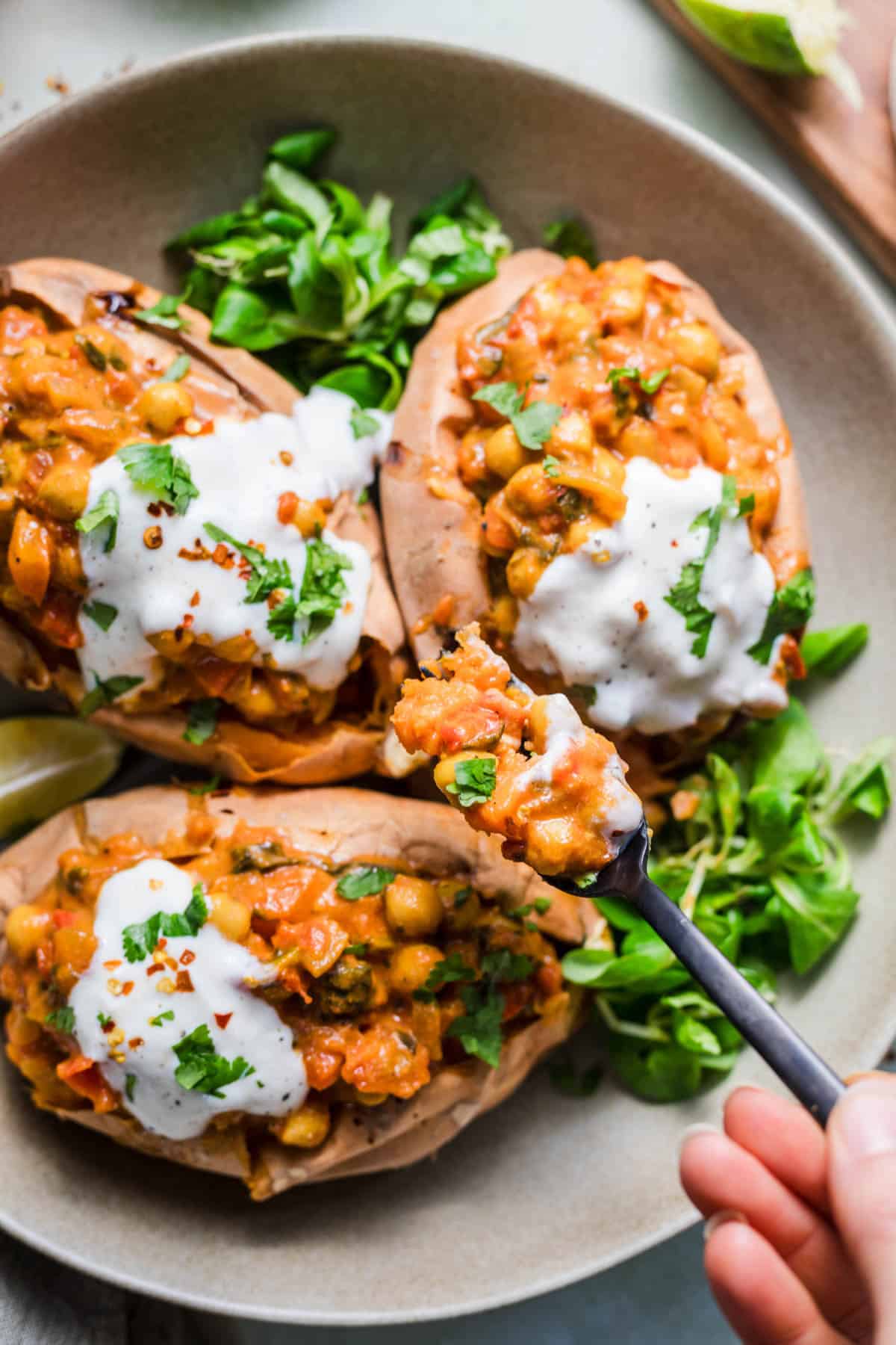 Close-up of a sweet potato stuffed with vegan chickpea curry